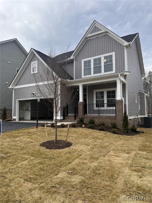 Craftsman house with central AC, a front lawn, and