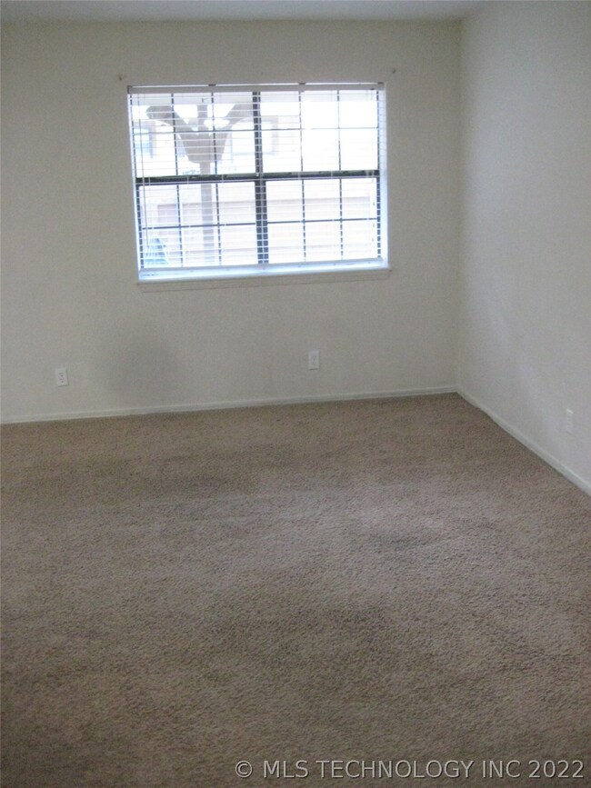 Double Windows with Blinds over looks Covered Porc