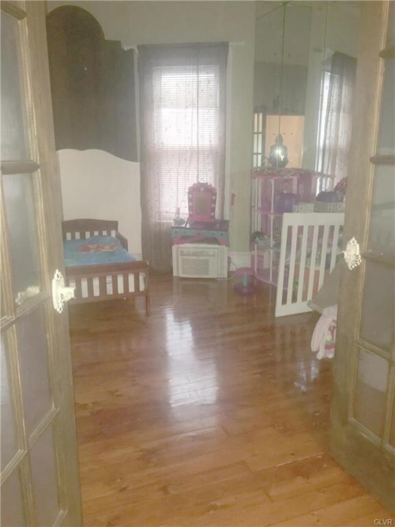 french doors connect the front bedroom to the second bedroom