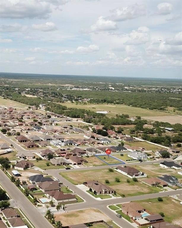 Aerial view of property's location with nearby suburban area