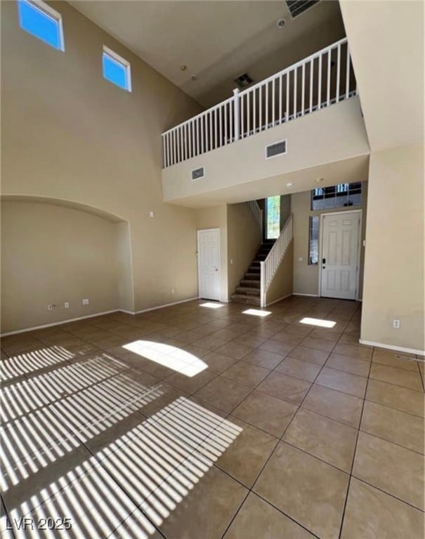 Unfurnished living room featuring tile patterned f