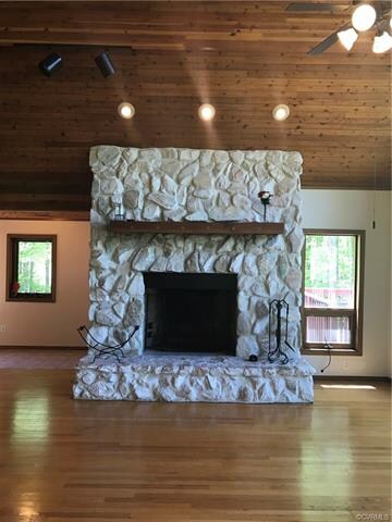How about this gorgeous true stone wood burning fireplace with a beautiful rustic wood mantle.
