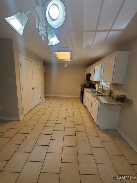 Kitchen photo with ceramic tile and washer/dryer/p