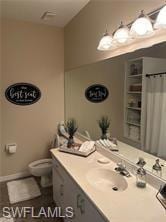 Bathroom featuring a shower with curtain, toilet, 