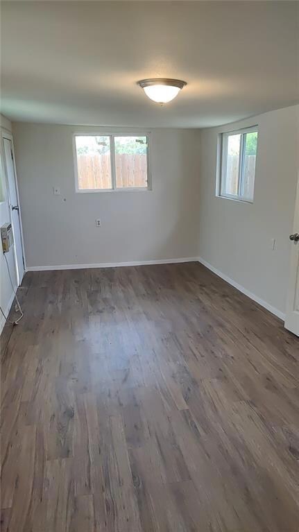 Empty room with baseboards and wood finished floo