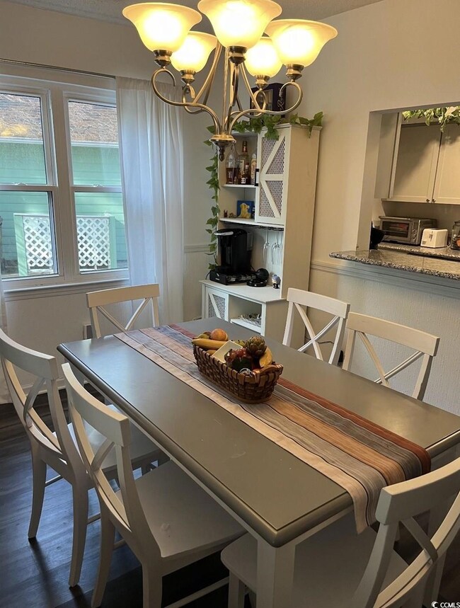 Dining area featuring dark wood-type flooring and 
