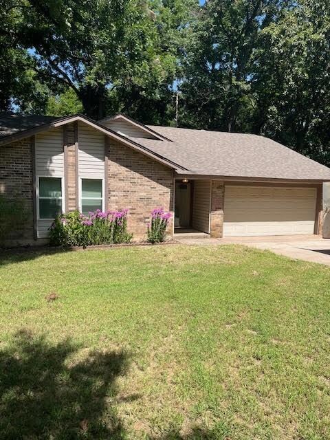 Single story home featuring a garage and a front l