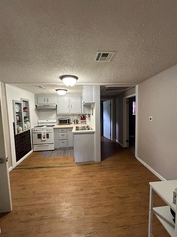 Kitchen featuring built in shelves, white range ov