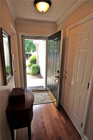 Foyer with Hardwood Flooring and Storm Door