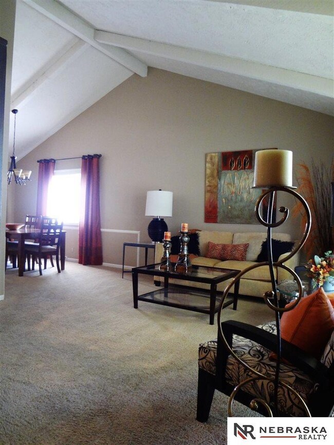 Main floor living room with cathedral ceiling.