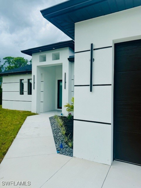 Doorway to property with stucco siding
