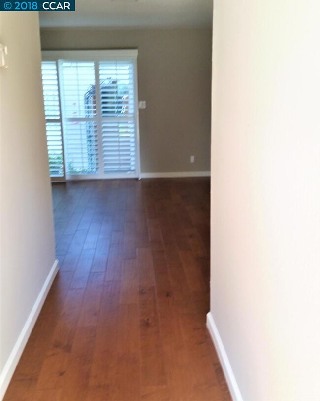 Hardwood flooring leading to private patio