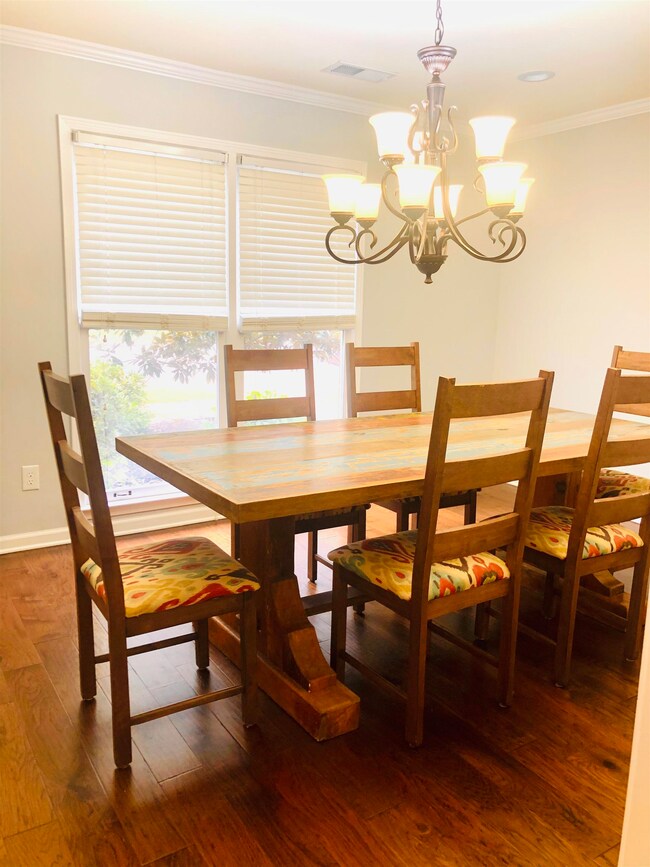 Dining room with hardwood / wood-style flooring, a