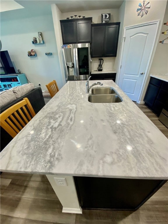 Kitchen featuring wood finished floors, a sink, a