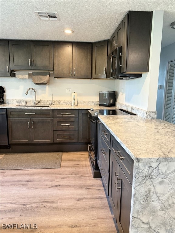 Kitchen with light wood-style flooring, a peninsul