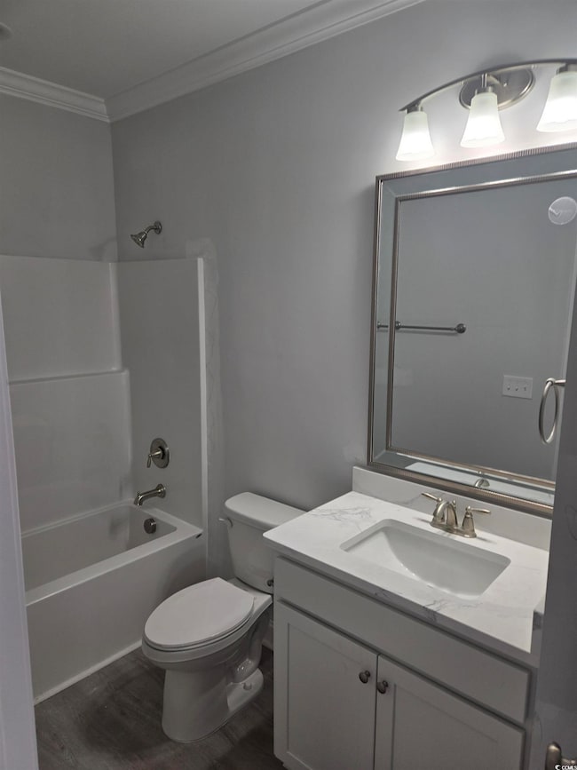 Full bathroom with toilet, hardwood / wood-style f