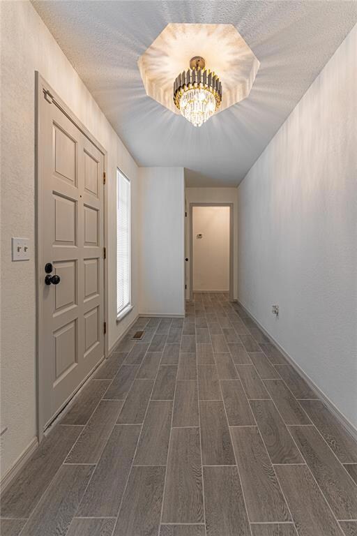 Foyer entrance featuring an inviting chandelier, w
