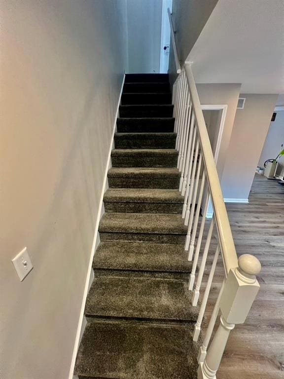 Staircase with hardwood / wood-style floors