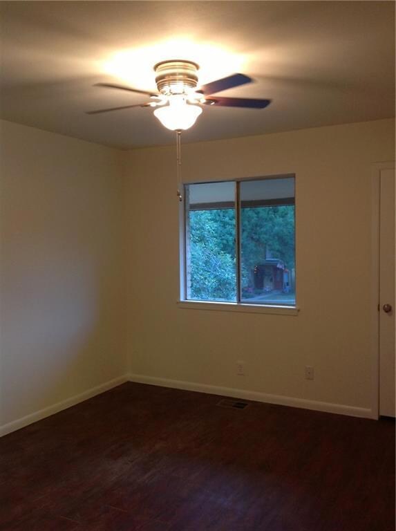 Spare room with a ceiling fan, baseboards, and da