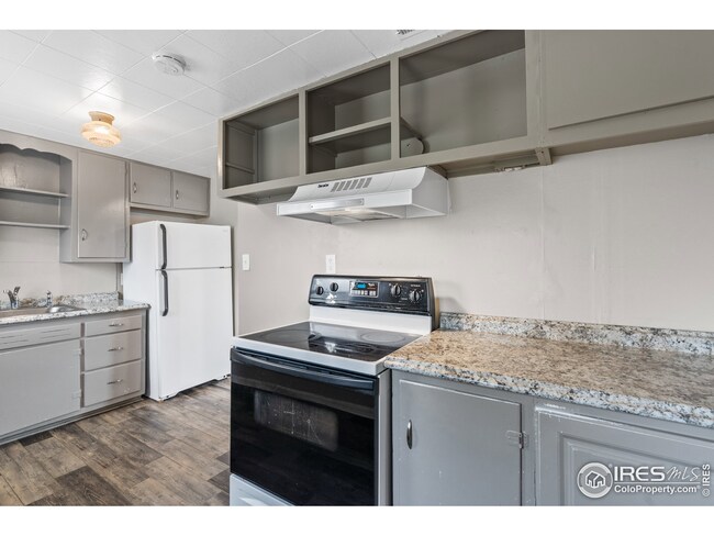 Updated kitchen with vinyl plank flooring, new countertops, and updated appliances.