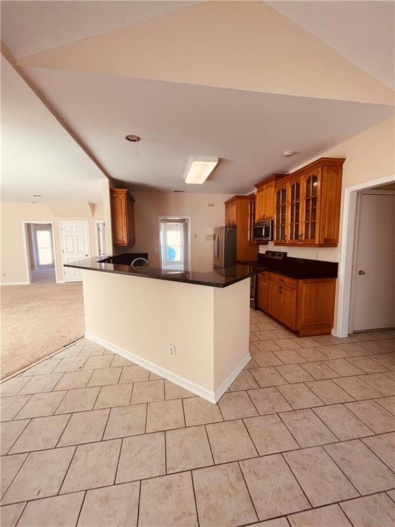 Kitchen with stainless steel appliances, dark coun