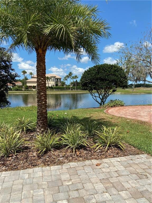 view of side of property from driveway apron. Uniquely situate and designed to accentuate water and golf course views!