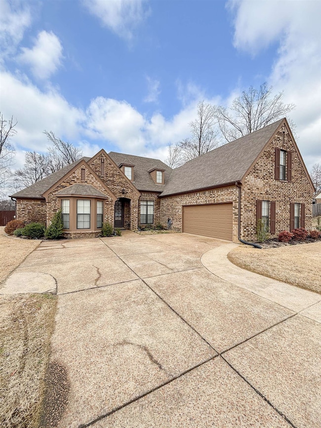 View of front of home with concrete driveway, ston