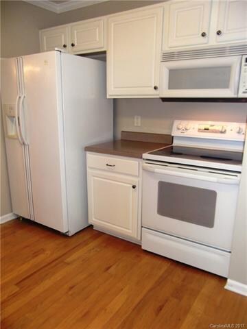 Kitchen with white appliances and cabinets