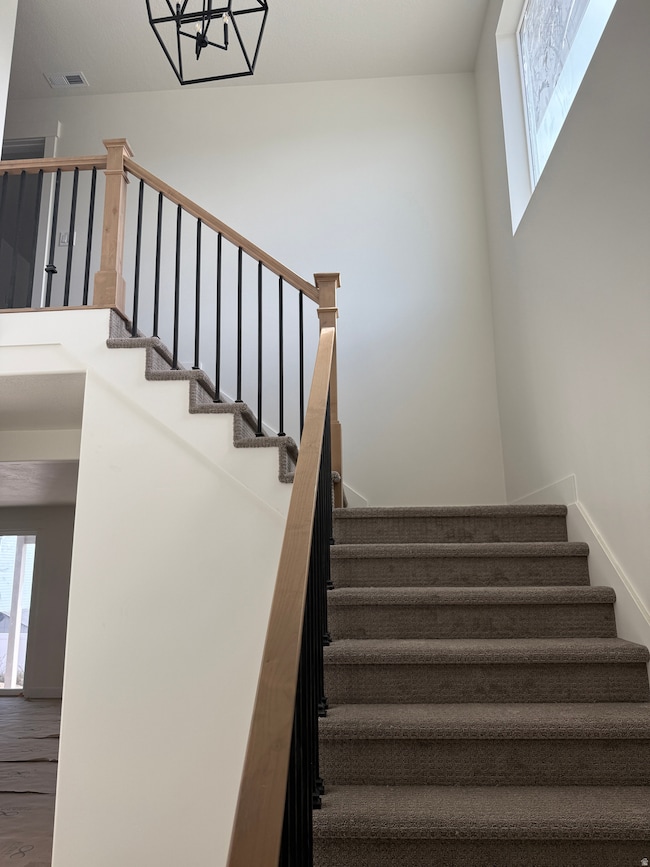 Stairway featuring wood finished floors
