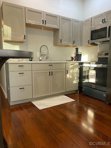 Kitchen with stainless steel appliances, dark wood