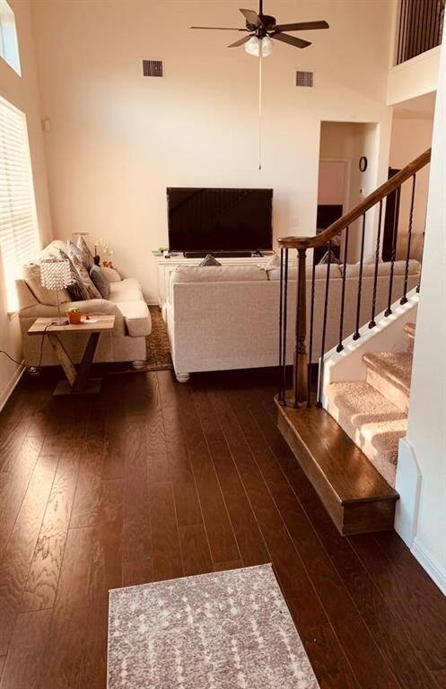 Living room with dark wood finished floors, ceili