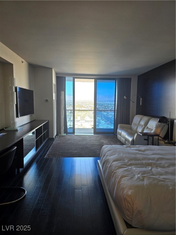 Bedroom featuring dark wood-style floors and expan
