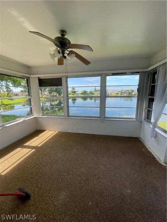 Unfurnished sunroom featuring a water view and cei