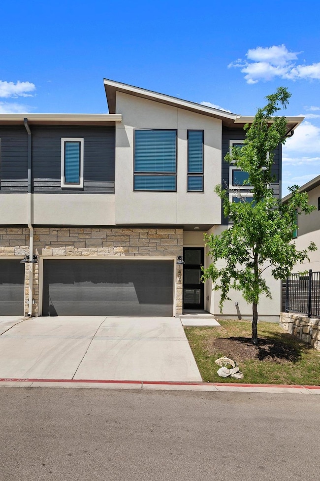 View of front of home with driveway, stucco sidin
