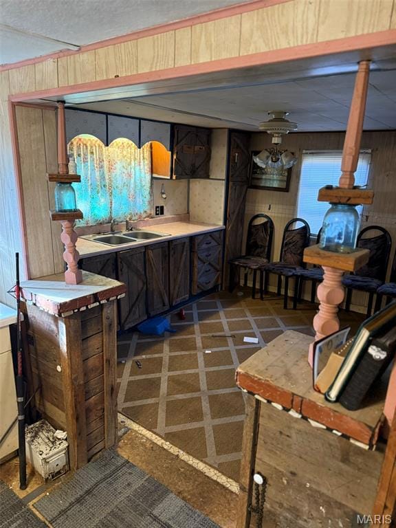 Kitchen with wooden walls and light countertops