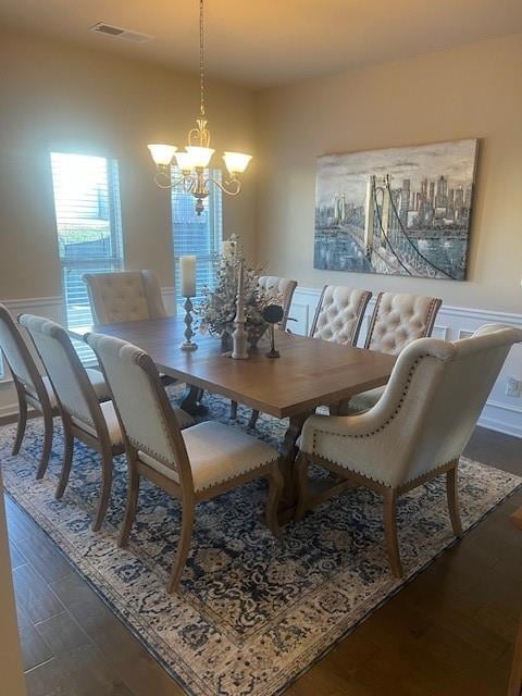 Dining space featuring dark wood-style floors, vis