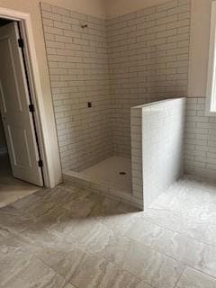 Full bathroom with a stall shower and tile pattern