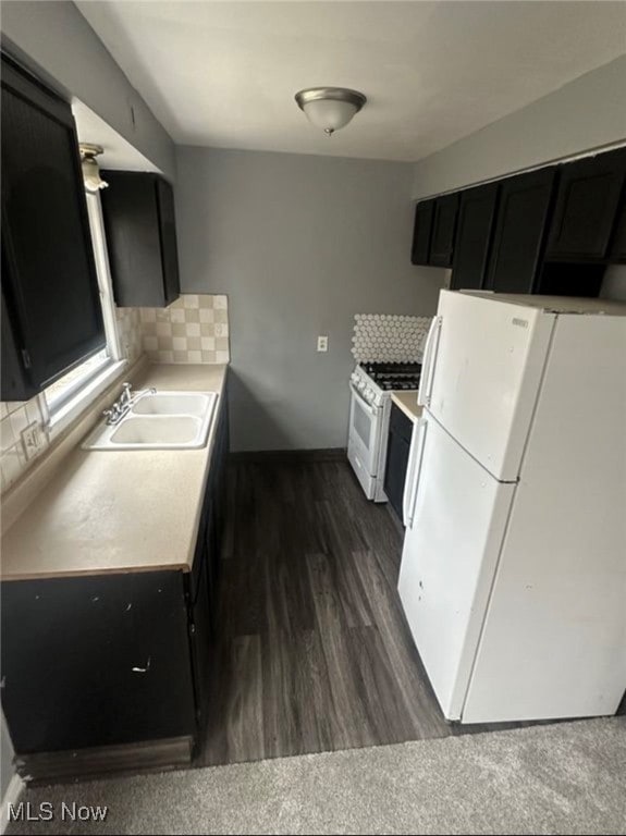 Kitchen featuring decorative backsplash, dark cabinetry, and light countertops