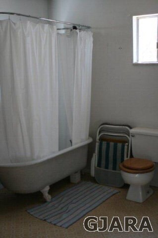 Large bathroom, with toilet, tub/shower.
