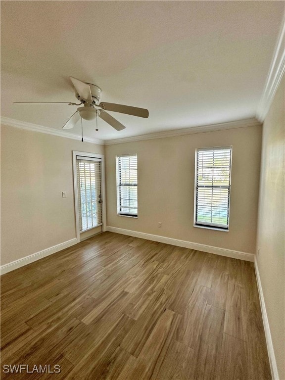 Spare room with ornamental molding, wood finished floors, and ceiling fan