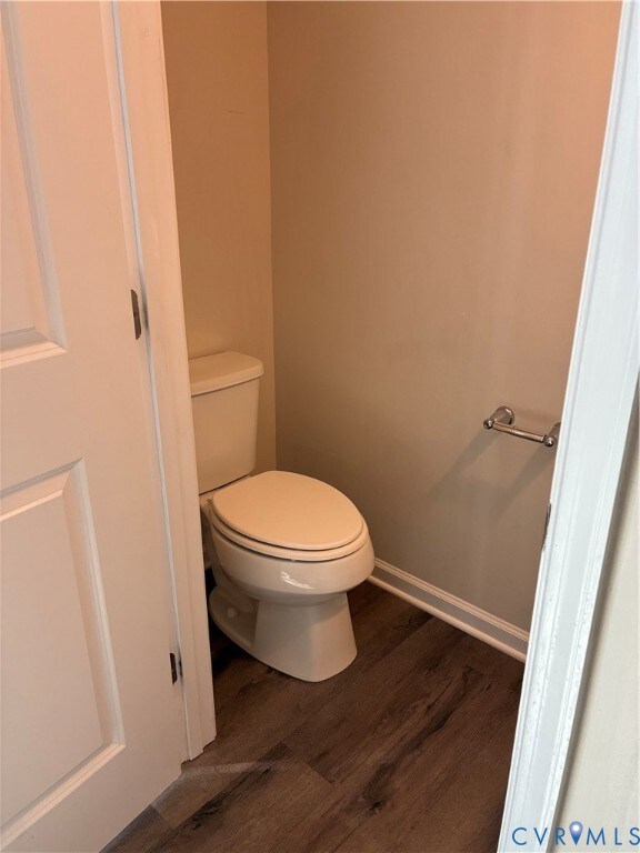 Bathroom featuring dark wood-style floors and baseboards