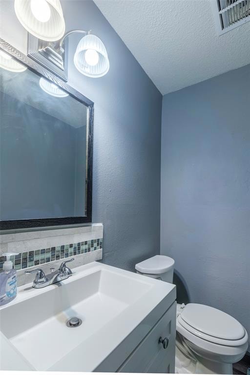 Bathroom featuring vanity, backsplash, and a text