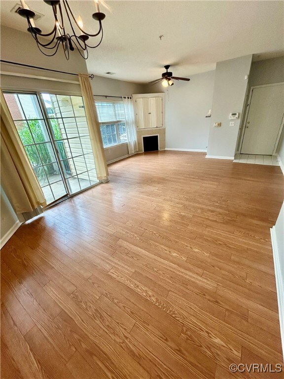 living space with a gas F/P, ceiling fan, light wo