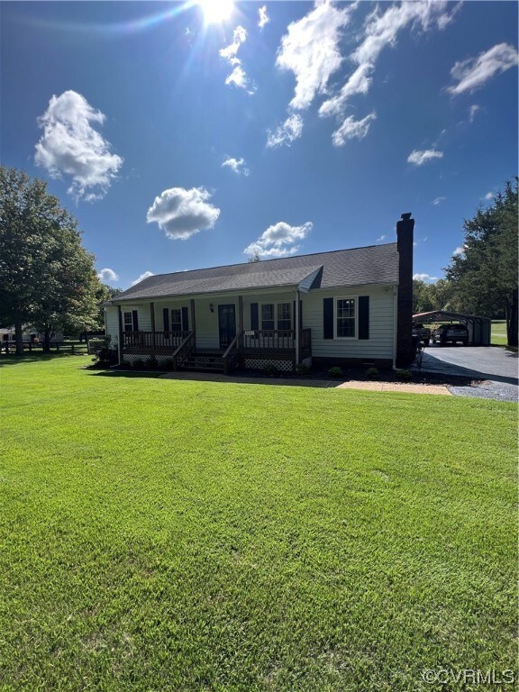 View of front of home with a front yard and a porch