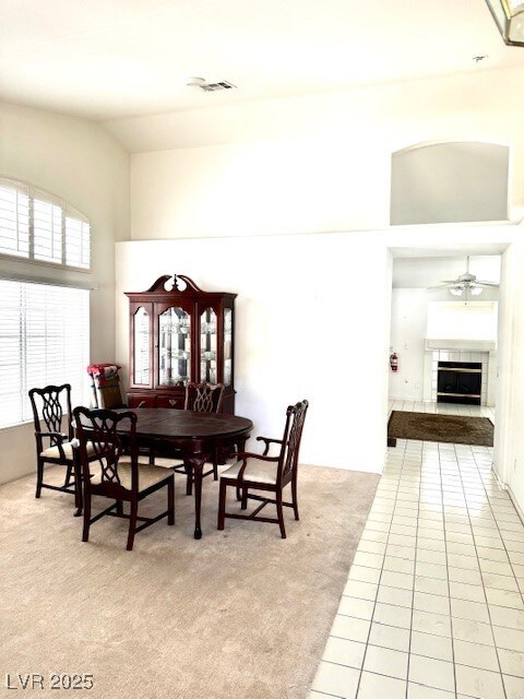 Dining space featuring light colored carpet, high
