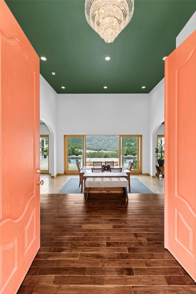 Bedroom featuring wood finished floors, a high ce