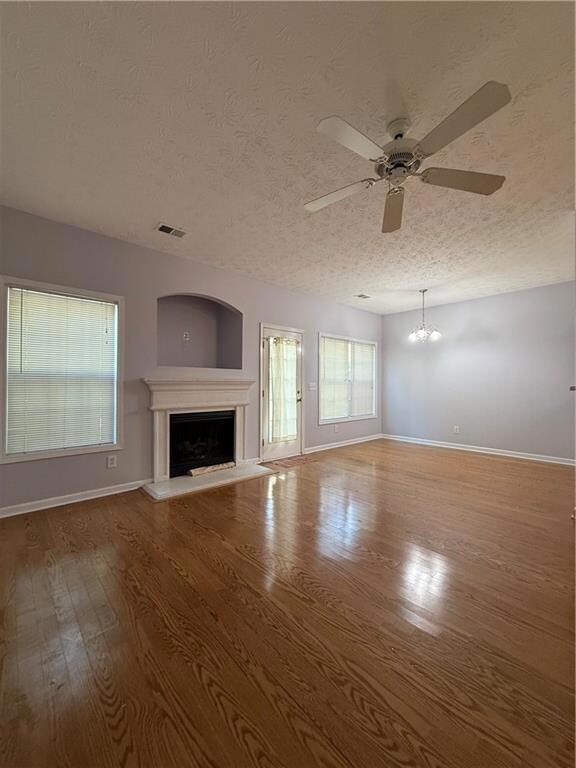 Unfurnished living room with visible vents, basebo