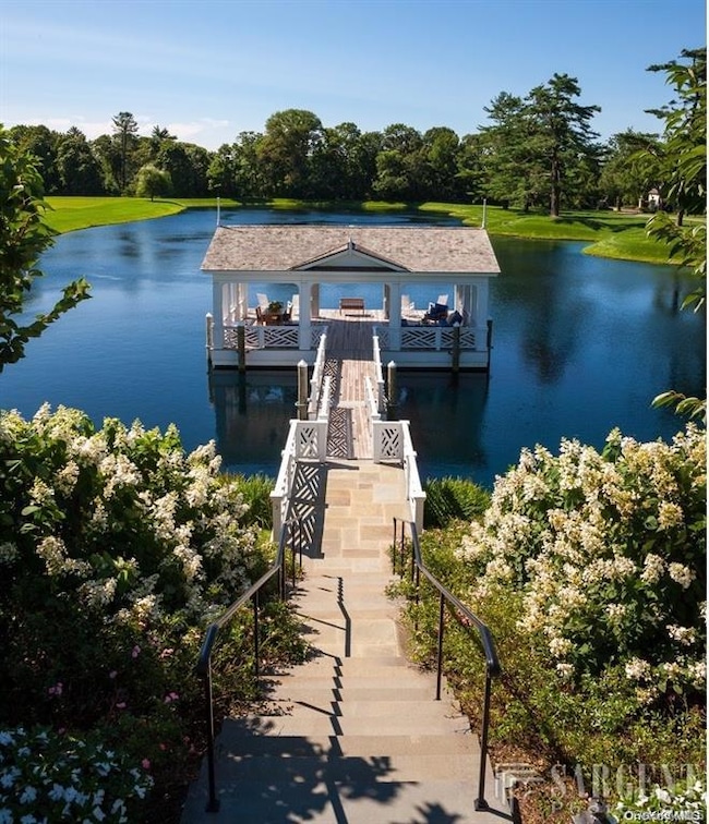 Dock featuring a water view and view of wooded area