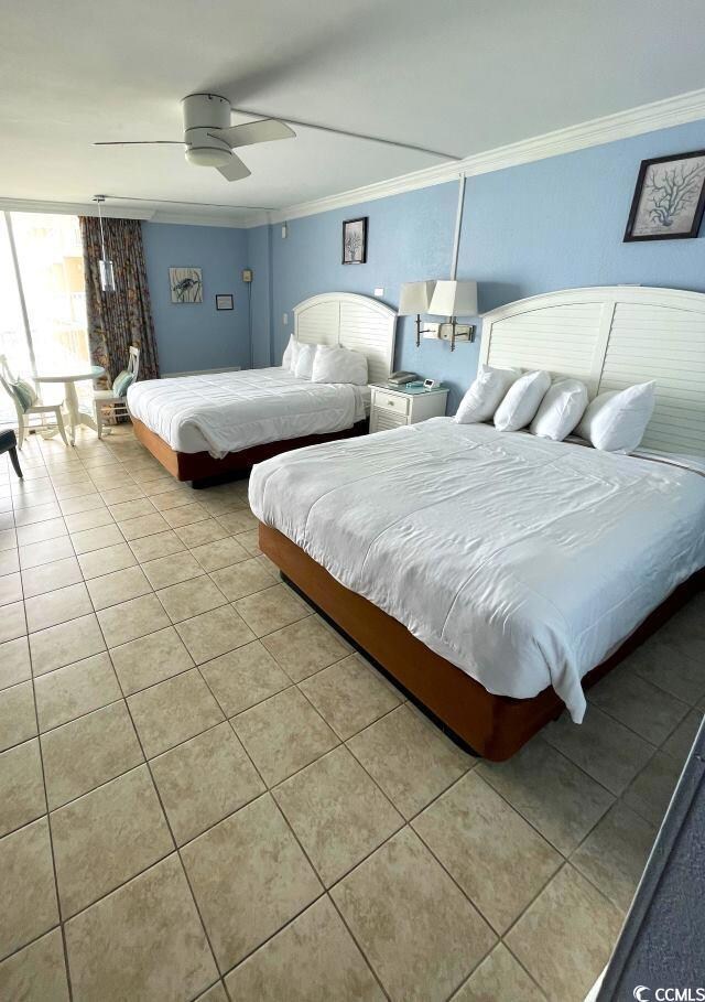 Bedroom featuring ceiling fan, crown molding, and 