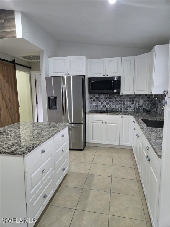 Kitchen featuring stainless steel fridge with ice